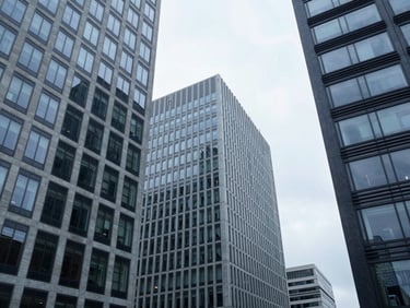 Low-angle architectural shot of Waterloo business district, clean modern glass facades, bright overcast daylight, cool slate tones, 35mm