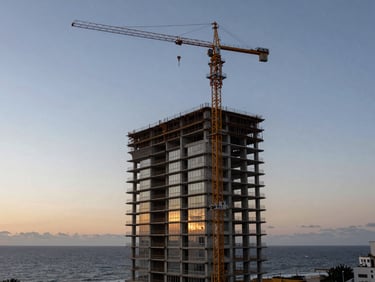 Wide environmental twilight shot of a modern skyscraper under construction in Balneário Camboriú, crane silhouette, geometric concrete slabs, ocean horizon background