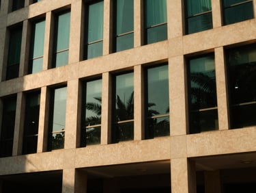Architectural detail of a premium Colombo office building interior, golden hour lighting, deep shadows.