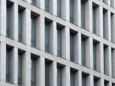 Abstract architectural detail of a modern steel and concrete building facade, sharp focus, cool corporate tones