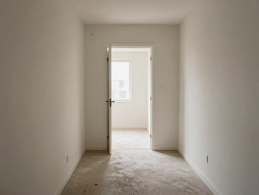 Empty freshly cleaned rental flat hallway photographed straight-on under natural daylight — bare walls, clean skirting boards, no furniture, door open to a bright room beyond — showing a ready-for-inspection property