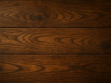 Extreme close-up of hardwood flooring planks, rich walnut grain visible under warm window light, slight wear and patina showing natural character, overhead framing