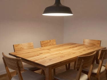 Wide-angle view of a complete dining room scheme, oak table set without place settings, pendant light above, chairs in clear arrangement, warm even daylight, no people