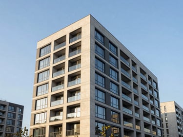 Crisp architectural elevation of a completed modern luxury apartment building, golden hour lighting highlighting premium concrete and glass facades.