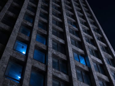 Moody architectural lines of a concrete and steel skyscraper reaching upward, low-key lighting, cosmic blue ambient glow