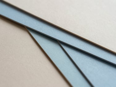 Extreme close-up of heavy tactile paper stocks, neutral color swatches in light beige and sky blue, soft natural shadows, minimalist composition.