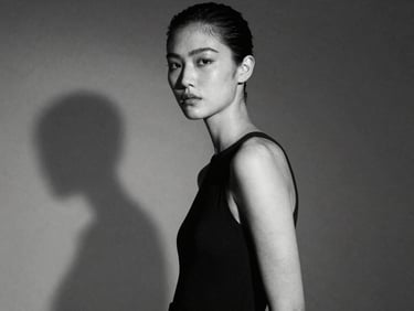 High-fashion editorial portrait of a model with sharp studio shadows, high contrast monochrome, elegant composition, 35mm
