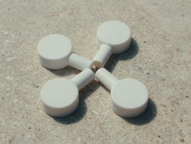 Landscape aspect, overhead geometric arrangement of three minimalist scatter tubes on a soft stone surface, showing clean circular lids and seamless joins, soft diffused daylight.