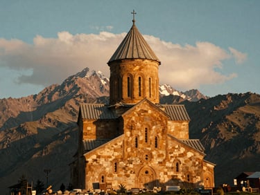 Gergeti Trinity Church at golden hour, Mount Kazbek towering in the background with soft clouds, warm cinematic 35mm photography.