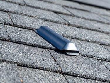 Extreme macro detail of precisely installed metal flashing on a slate gray shingle roof, sharp focus, high contrast, bright direct California sunlight, deep blue and slate gray tones, 35mm lens