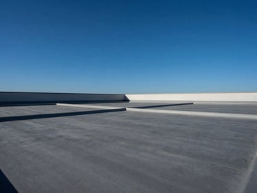 Wide architectural shot of a large commercial flat roof with visible structural integrity, clean edges, against a deep blue sky, bright direct California sunlight, deep blue and slate gray tones, sharp focus, 35mm lens
