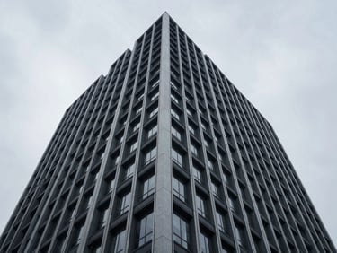 Wide-angle architectural view of a completed modern commercial high-rise with high-contrast structural grids under cool daylight