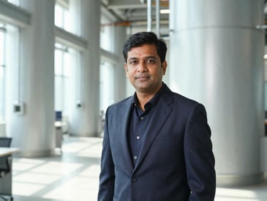 Professional portrait of Lalit Kumar Agrawal in a modern industrial office setting, bright clean lighting, high contrast.