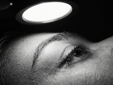 Extreme close-up of fresh black-and-grey ink on skin, sharp details of fine-line shading under dramatic studio lamp, high-contrast black and white photography, 35mm film grain