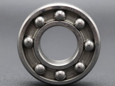 Macro close-up of a pristine chrome steel ball bearing, high contrast, metallic reflections, neutral workshop background