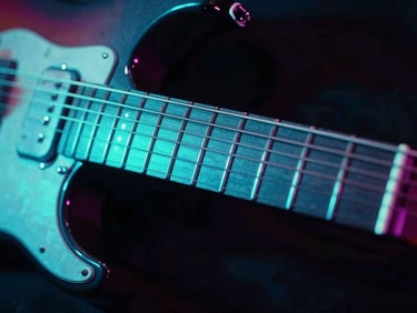 Extreme close-up of a neon-glowing electric guitar fretboard with cyan backlighting, high contrast, 35mm lens