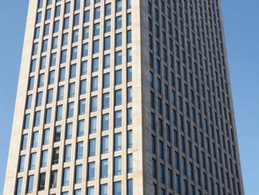 Modern corporate skyscraper facade in Madrid financial district, clean lines, bright daylight, reflections of blue sky, architectural photography