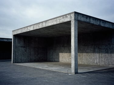 Wide-angle architectural perspective of a minimalist concrete pavilion under cool overcast daylight, sharp shadows, deep charcoal tones, 35mm.