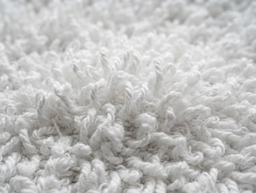 Close-up macro photography of clean white terry towel loops under bright neutral daylight, crisp textile textures, desaturated teal tones, 50mm lens