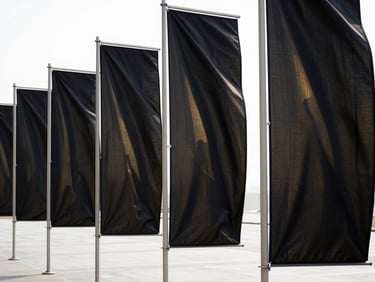 Modern wind banners catching natural wind outdoors on a clean corporate plaza, sharp textile textures, high-contrast lighting