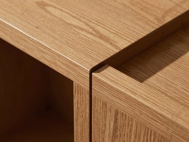 Overhead close-up of a hand-cut dovetail joint on a custom cabinet face frame, warm amber oak grain under diffused north light, sharp shadow in the joint gap