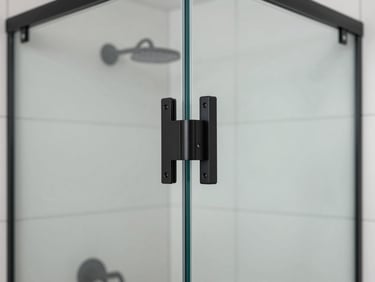 Modern frameless glass shower enclosure with heavy-duty matte black metal hinges, clean silicone seal, high-contrast interior, sharp focus