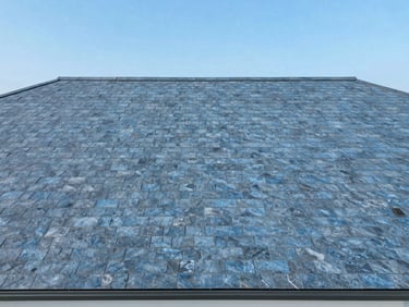 Clean overhead drone shot of a completed residential roof with perfect structural alignment under clear skies, slate blue tones