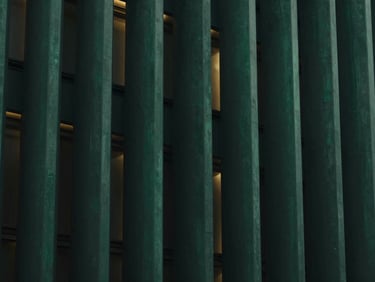 Abstract architectural geometry with subtle gold light leaks, representing a protected vault of intellectual capital, deep obsidian and emerald tones, sharp focus, cinematic architectural photography, 35mm anamorphic lens.