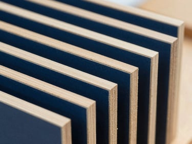 Close-up of nested architectural millwork components cut from premium birch plywood, clean edges, technical precision