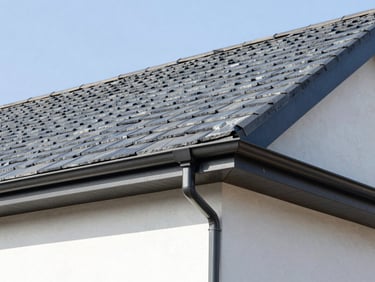 Sharp architectural shot of a newly tiled house roof with clean dry verge systems installed along the gable edge, bright daylight