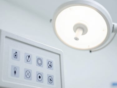 Close-up of a medical device control panel with regulatory certification labels, bright clinical light, crisp white backdrop.