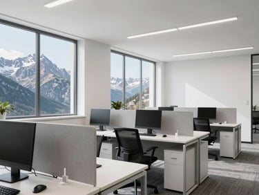 Bright, modern office interior with flexible desk layouts, clean white walls, and large windows looking out to mountain peaks.