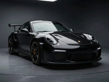 Dramatic 3/4 front angle of a black Porsche 911 GT3 RS, dramatic low-key automotive photography, moody studio lighting on polished metallic surfaces, deep shadows, high contrast, 50mm.