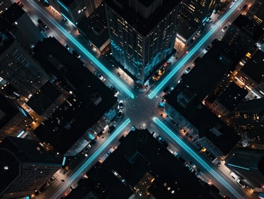 Overhead bird's-eye view of a dark city grid at night with glowing electric cyan light trails representing real-time vehicle dispatch routes.
