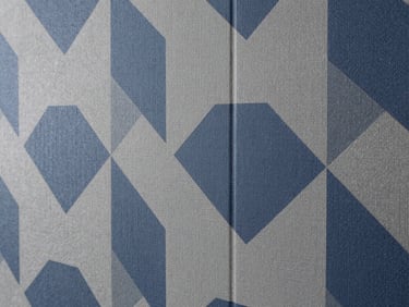 Architectural detail of premium wallpaper with geometric patterns perfectly aligned at the seam, slate grey and deep blue tones, 35mm.