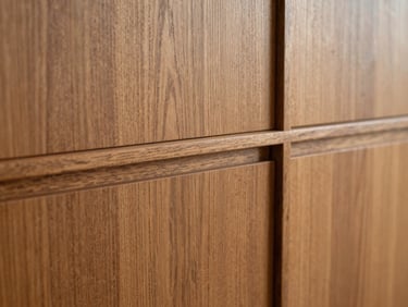 Architectural millwork detailing on a custom hardwood cabinet, tactile wood texture, shallow depth of field