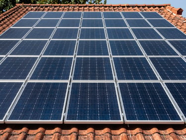 Immaculate solar array integrated seamlessly onto a tiled roof, straight-on symmetrical composition, bright daylight