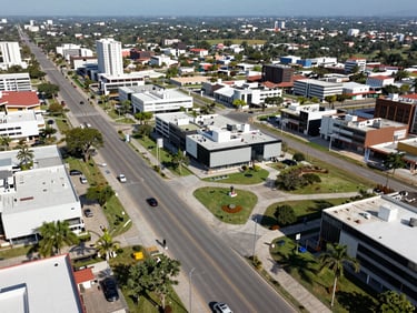 Wide aerial view of Nueva Santa Cruz smart city development, clean paved avenues, modern infrastructure, green spaces