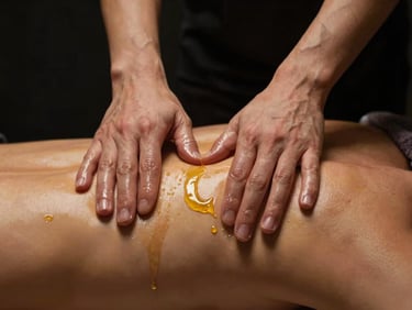 Precise hands-on massage therapy technique on shoulders, warm gold oil glistening, low-key dramatic lighting, dark background
