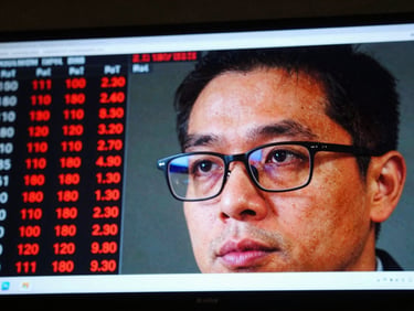 A close-up of a digital financial stock ticker screen reflecting on a businessman's glasses, high-contrast saturated colors.