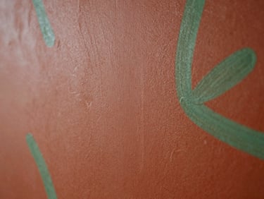 Abstract textured painting with deep terracotta and moss green brushstrokes, natural light, organic forms, 35mm photography