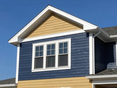 Flawless residential exterior showing newly installed premium siding and crisp white architectural trim under clear blue sky, sharp focus