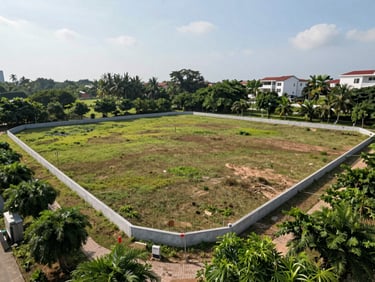 Empty residential land plot in Liên Chiểu district Đà Nẵng, clear boundary markers, surrounding greenery, bright daylight overhead shot