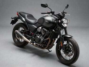 Close overhead studio shot of a naked street motorcycle, matte dark finish, sharp hard-shadow lighting on neutral grey floor, no background clutter