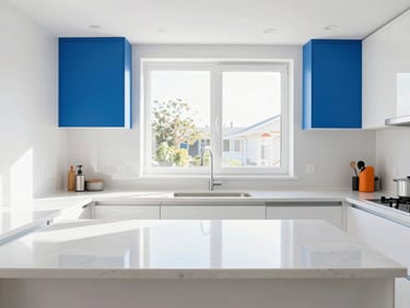 Straight-on architectural shot of an immaculate modern kitchen with pristine white quartz countertops, bright high-key lighting, crisp natural sunlight pouring through windows, vivid blue accent decor, 35mm