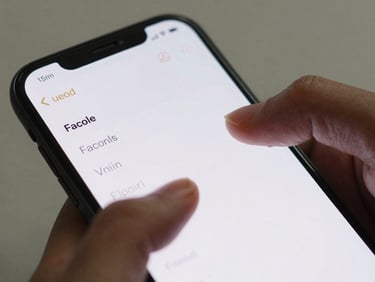 Close-up of Android phone screen showing a minimal note-capture interface, thumb scrolling through short notes, natural daylight, crisp UI text legible on screen, plain surface background