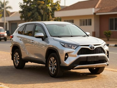Eye-level three-quarter view of a clean silver Toyota SUV parked in bright Nigerian sunlight on a paved lot, clear reflections, 35mm lens.