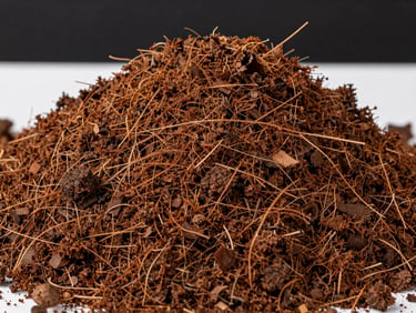 Close-up of rich, textured organic coco peat fibers, sharp focus, natural brown tones against a clean dark industrial background.