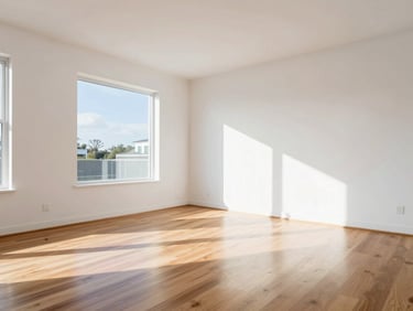 Sunlit modern residential living room with polished hardwood floors, crisp white walls, bright natural daylight, sharp focus