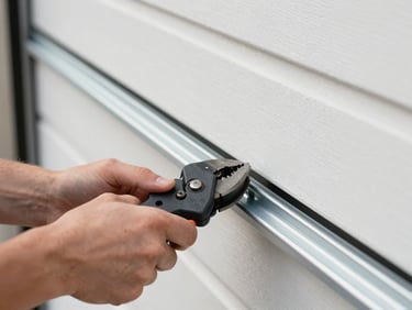 Close-up of hands using professional tools to align a clean steel garage door track, bright daylight, 35mm lens.